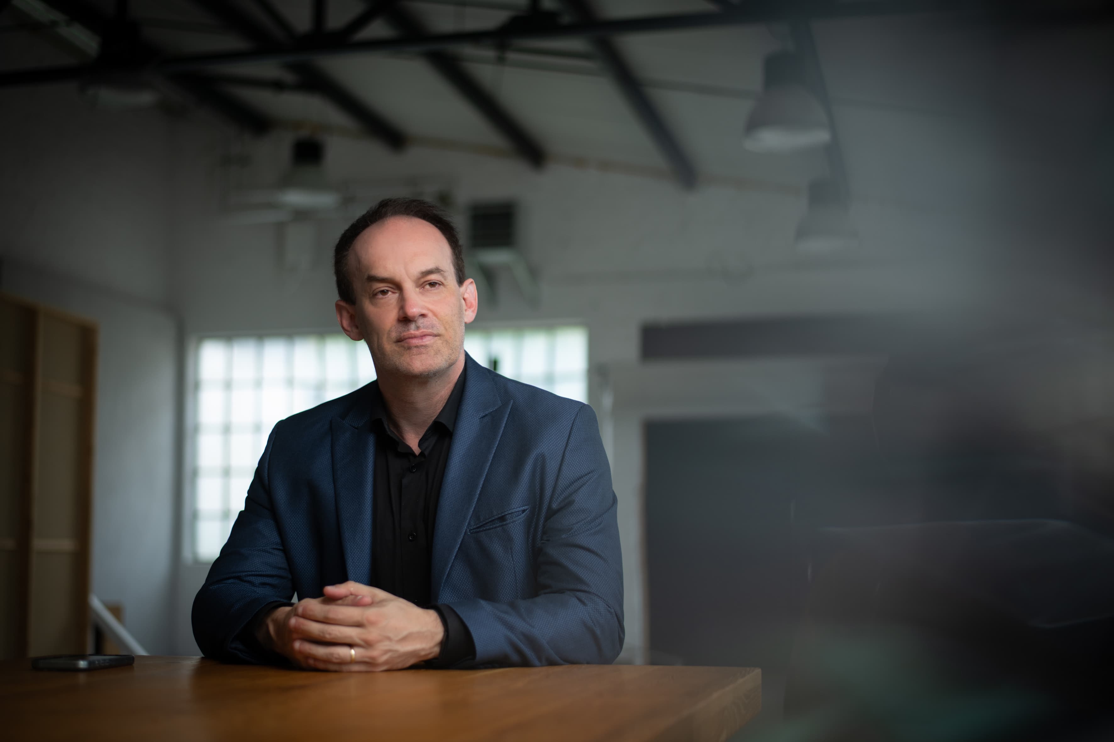 Michael Backes in conversation with a business leader across a conference table